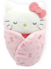 Drift off to dreamland with Sanrio’s Snuggle Baby Hello Kitty in Swaddle Blanket. This swaddled, sleeping cutie with embroidered face is the perfect sleeping companion for kids. Also makes a great gift for a new mom with her own swaddled bundle of joy.